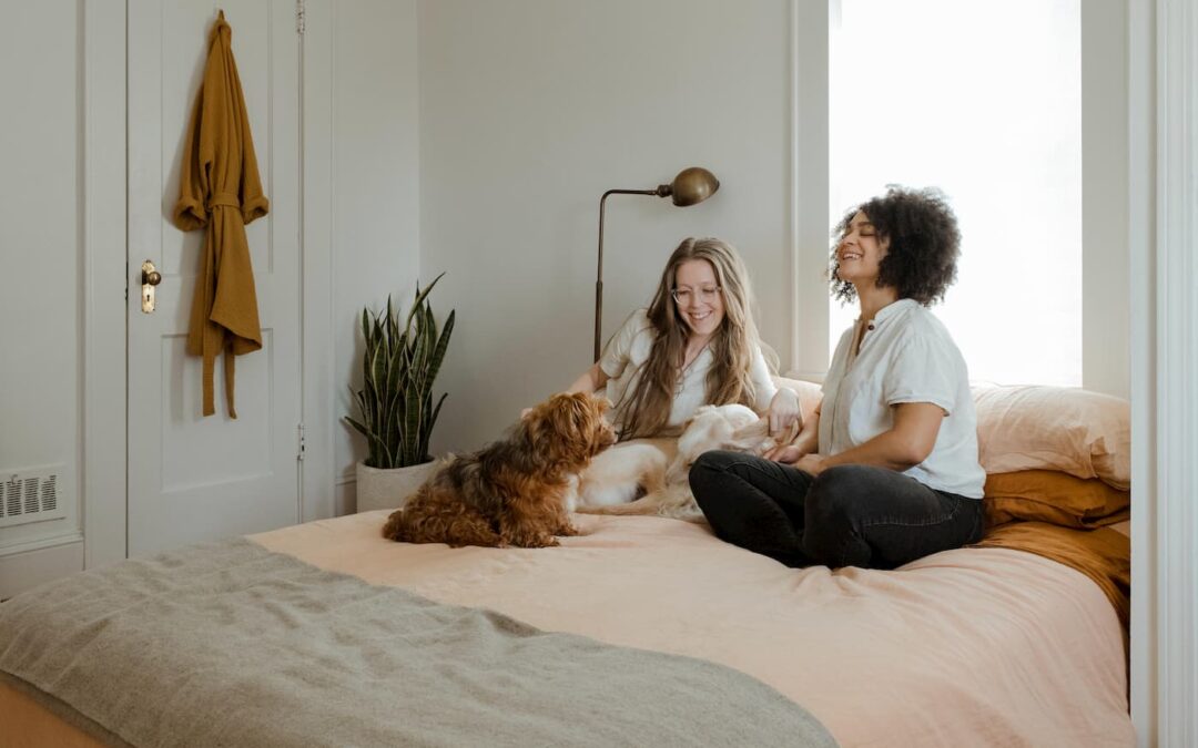 Happy long-term tenants sitting on their bed with their dog