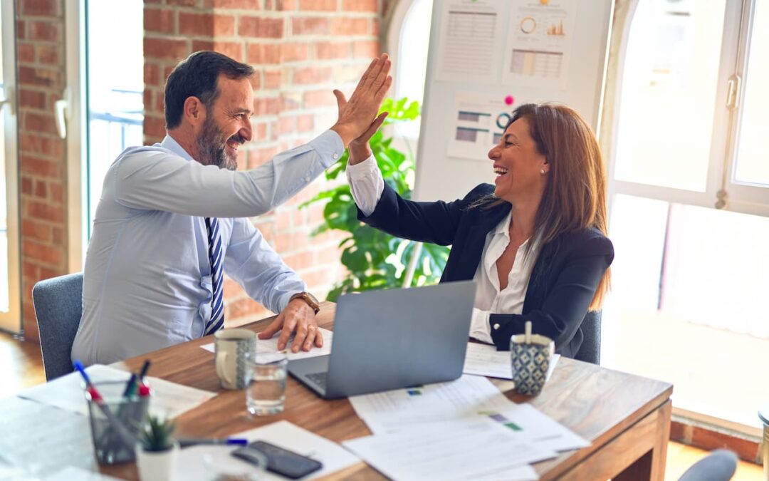 Two professionals exchanging a high-five after sharing useful property management tips