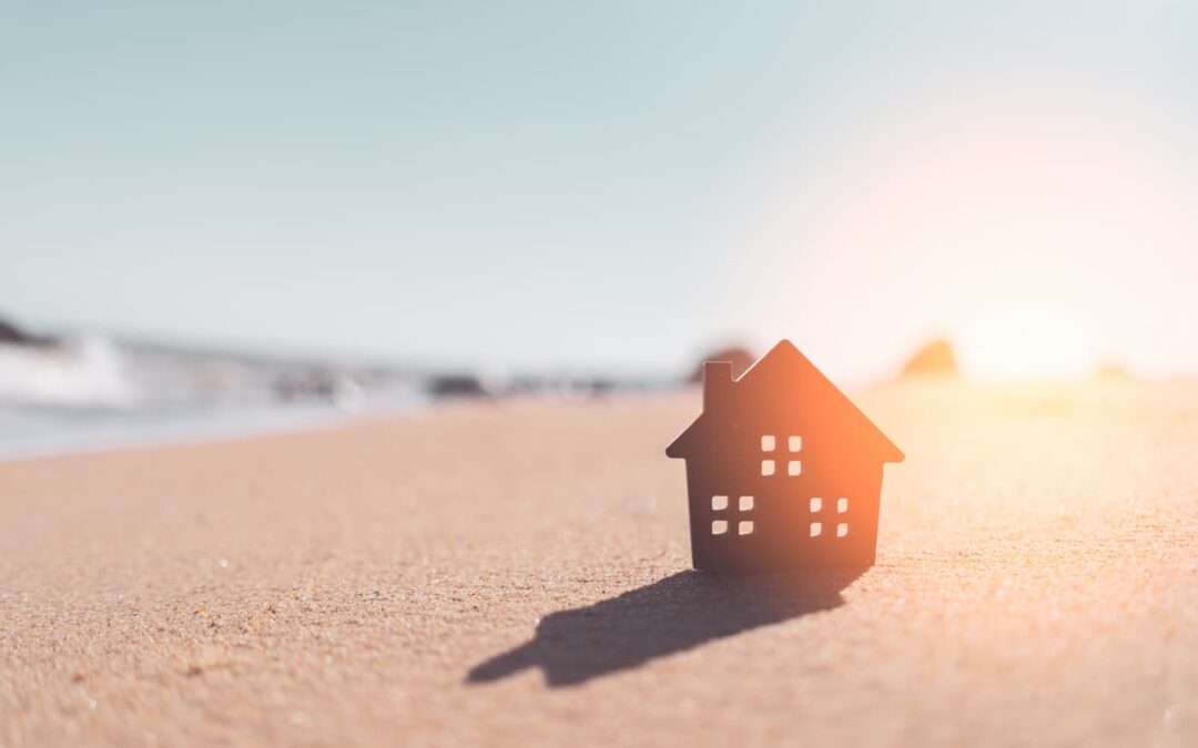 A model of a house on a sandy beach illustrating a short-term rental