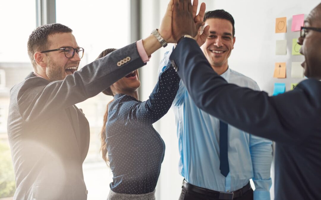 a property management team sharing a group high-five.