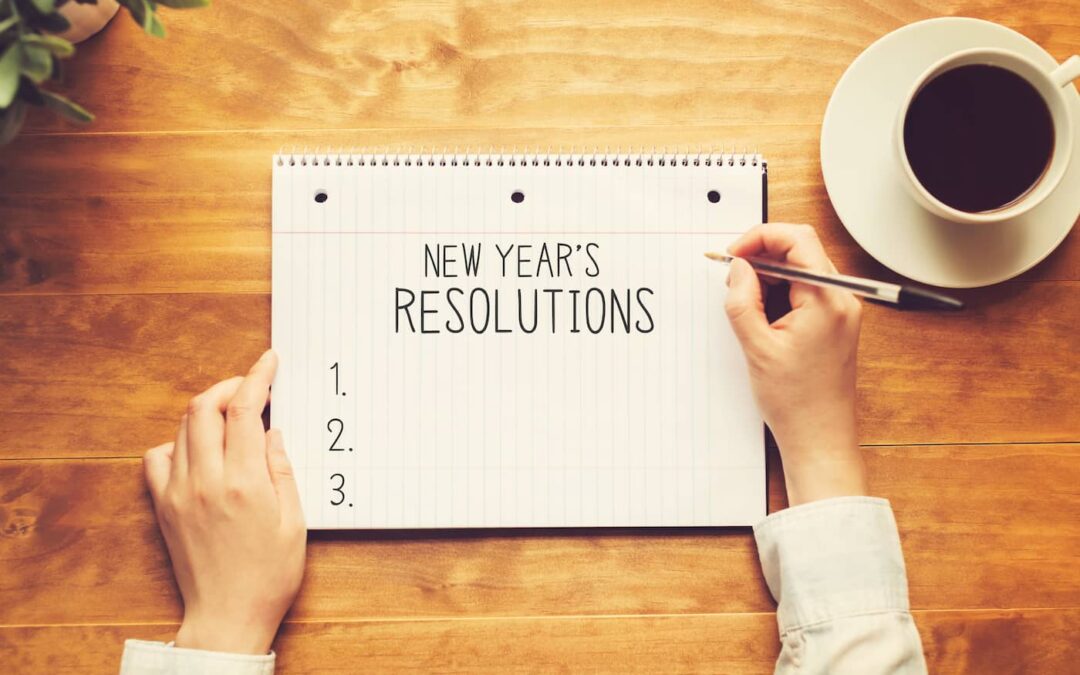 a person writing a list of resolutions for the new year.