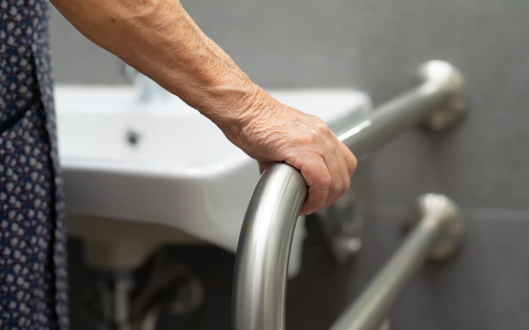 a person using a bathroom handrail in an accessible property