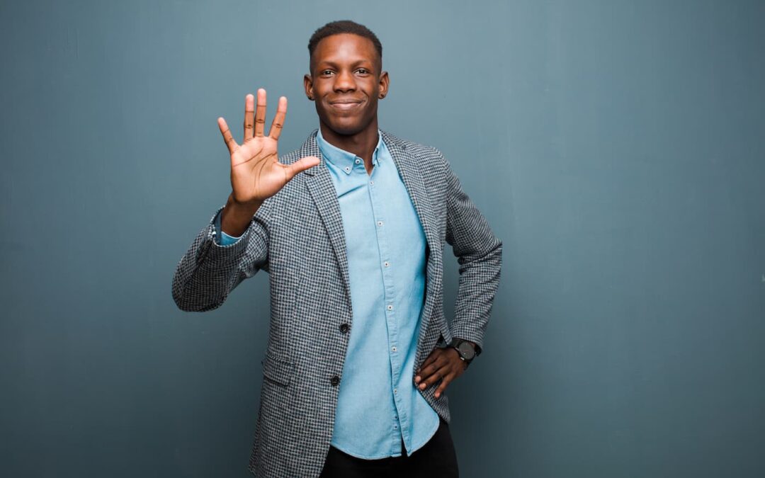 A man in a grey suit standing in front a blue background hold five fingers up as a way of indication the five reasons property owners should consider turning their rental property management responsibilities over to professionals