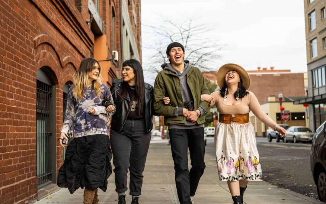 four friends walking down the sidewalk in the Alberta District