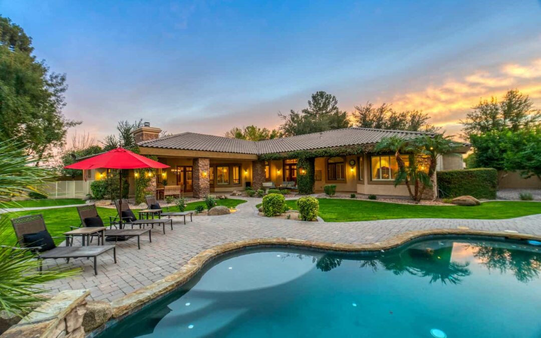 An exterior image of a luxury property witting next to a clear blue swimming pool